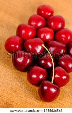 Groups of berry lie on wood board, macro, gradient selected, cropped, fragment