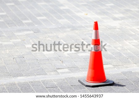 Orange traffic cone on the street 