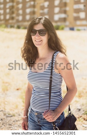 Beauty outdoors woman portrait with sunglasses in summer looking at camera