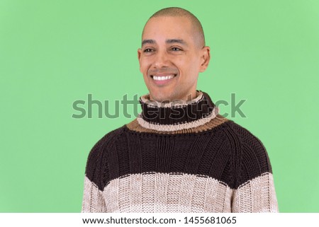 Face of happy bald multi ethnic man thinking ready for winter