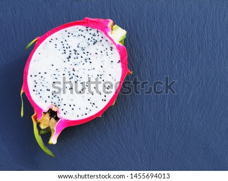 Dragon fruit top view on a dark background with copy space.