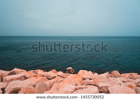 rocks at the ocean in cold colors