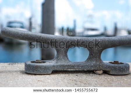 Empty coastal mooring or towing bollard for the boat, yacht or vessel. Bkue sky and marina as a background. Royalty-Free Stock Photo #1455755672