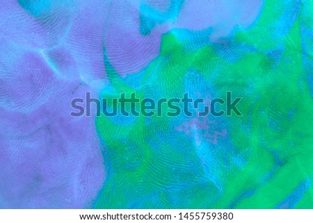 Mixed purple-green-blue flat plastilin texture with distinct finger prints. Small dust particles on surface.