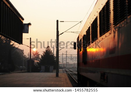 Railway train station view in sunset time. Transportation and travel moments. Journey, vacation starting. 