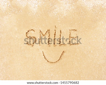 happy smile text on the sand