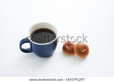 Coffee and Anpan bread on a white background.