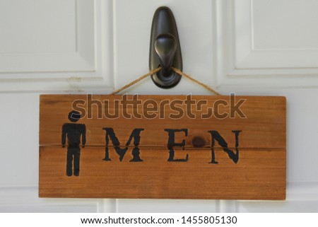 Wooden Men Restroom Sign Hanging On Door