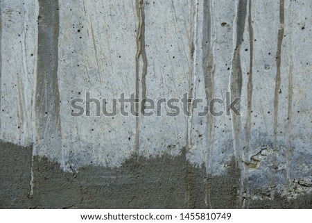 A closeup shot of naturally weathered grungy wall with oil paint leftovers on marble