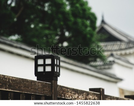 picture showing a close up of a lantern on a wooden fence in kyoto, japan
