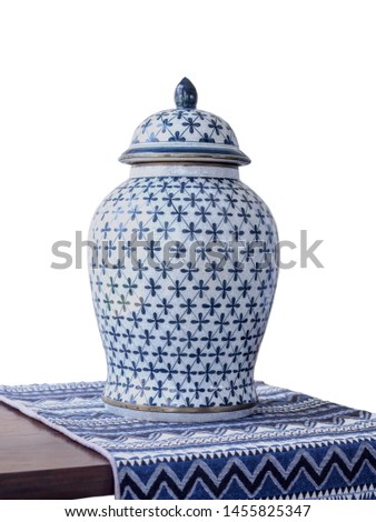 Antique Thai porcelain jar placed on a table covered with cotton on white background Royalty-Free Stock Photo #1455825347