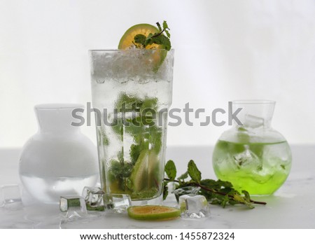 Mojito with mint leaves lemon slices and dry ice on white background 