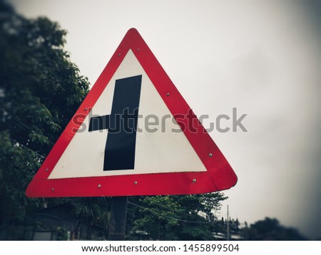 Three way junction warning sign board, intersection traffic sign on the roadside