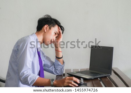 Desperate male company employee, Unemployment concept,Men who are stressed about finding work on the internet after being dismissed. Royalty-Free Stock Photo #1455974726