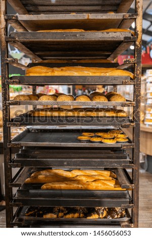 Fresh baked baguette bread and egg tart in confectionery factory