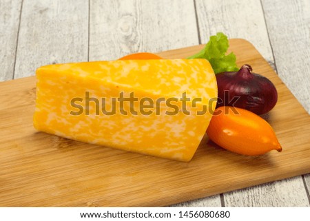 Marble cheese  triangle over wooden background