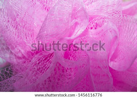 pink sponge with a handle. background. large area
