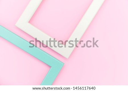 Simply design with empty pink and blue frame isolated on pink pastel colorful background. Top view, flat lay, copy space, mock up. Minimal concept