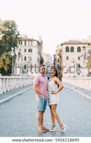 Happy couple at dawn strolling in Italy. Morning summer photo shoot in Rome. 
