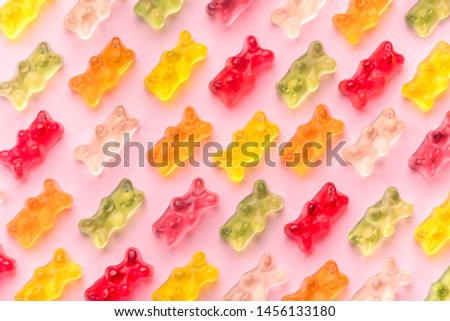 Flat lay composition with delicious jelly bears, jelly bears pattern on pink background Royalty-Free Stock Photo #1456133180