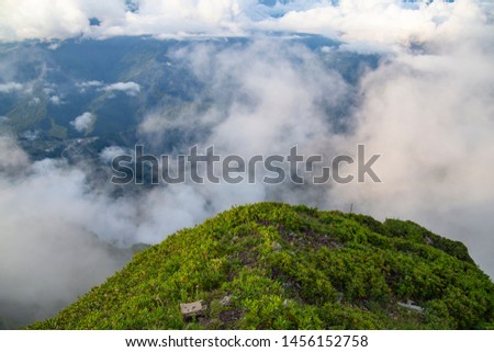 the slope of the mountain with cloud and mist