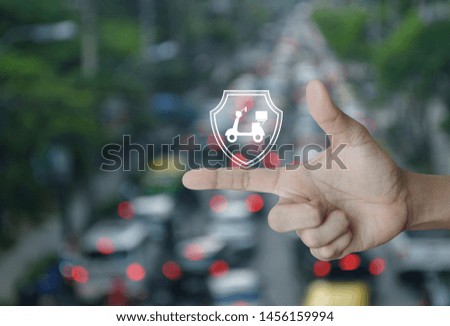 Motorcycle with shield flat icon on finger over blur of rush hour city road and cars, Business motorbike insurance concept
