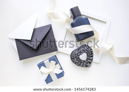 greeting card design. black and white composition. perfume bottle, envelopes and gift box on white background