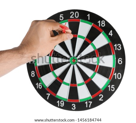 Young man throwing dart at board on white background, closeup