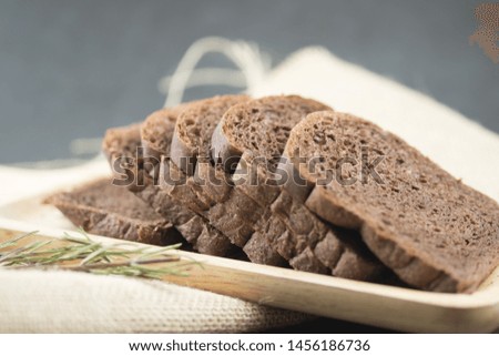 Chocolate bread sliced on wooden tray