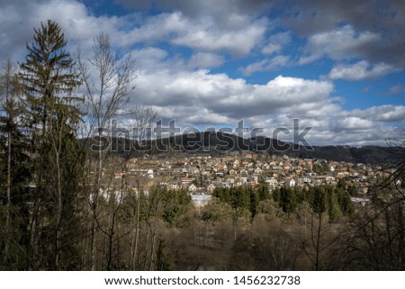 view from the hill from the forest to the small town houses in spring