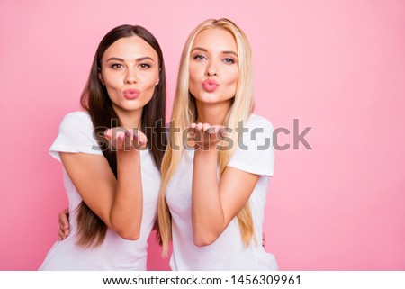 Photo of two coquettish ladies sending handsome guys air kiss wear casual outfit isolated pink background Royalty-Free Stock Photo #1456309961
