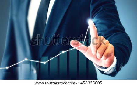 Businessman showing business growth on a chart, hands touch the graph that represents profit rises on a lot more.
 Royalty-Free Stock Photo #1456335005