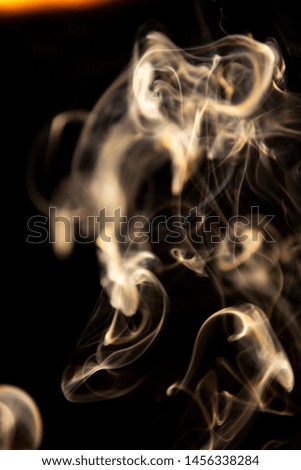 Movement of golden smoke on black background, smoke background