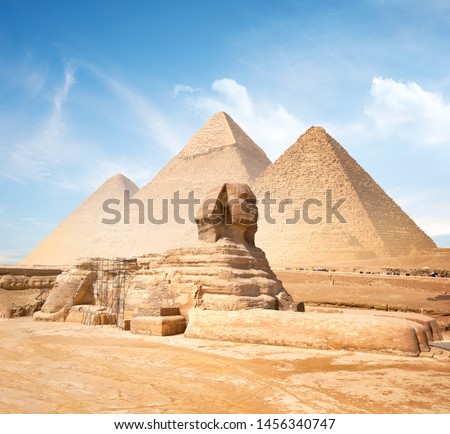 Great sphinx and pyramids under bright sun Royalty-Free Stock Photo #1456340747