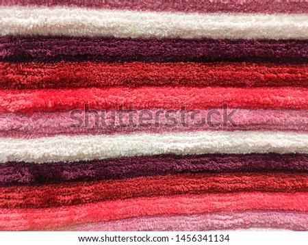 Close-up photos of colorful carpet or doormat pattern. Colorful carpet background texture.