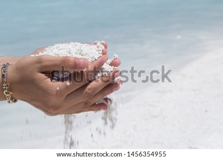 the woman hold Chyle or Argil or clay or sand in the hand at the Salda lake from Turkey.