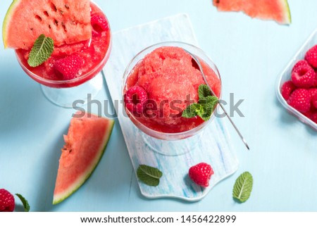 Watermelon slushy, summer refreshing drink on blue background, watermelon smoothie or granita, slush vegan frozen dessert