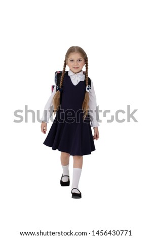 Little girl in stylish school uniform on white background  with school backpack
