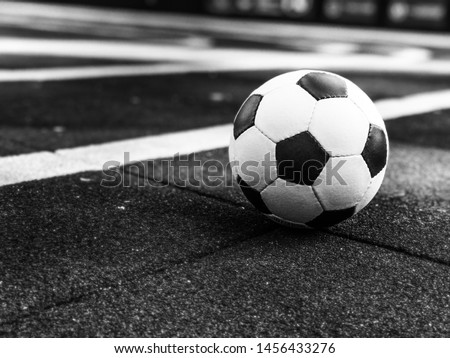 Soccer ball on the playground. Ball for playing street football on a street soccer field. Streetball. Soft focus with a small depth of field.