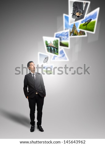 Businessman look digital  images in air