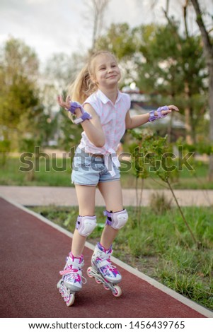 Little girl on roller skates  at a park