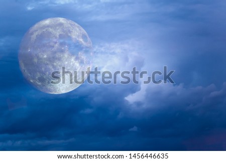 Dramatic moon in thunder clouds. Fantastic picture.