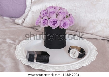 Beautiful Bouquet of flowers in a round hat box on a table or chair.