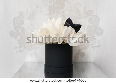 Beautiful Bouquet of flowers in a round hat box on a table or chair.