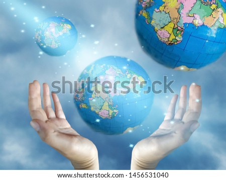 earth with hand on blue sky background