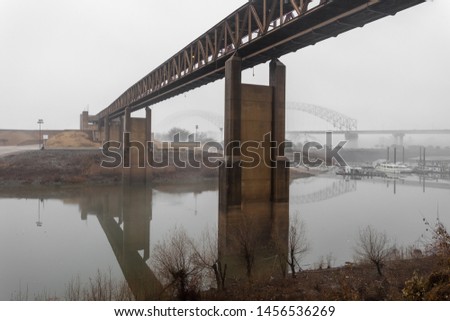 Long bridge over Mississippi river on day with heavy fog