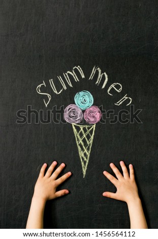children's hands reach for ice cream drawn with crayons on the blackboard concept of summer pleasure