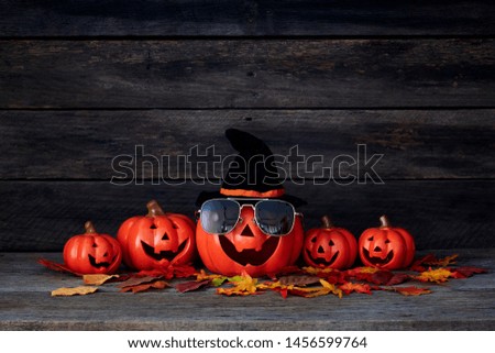 Happy Halloween pumpkin lantern. Trick or treat on a wooden table on a background of old wooden boards. Halloween background. Space for text.