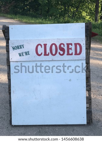 Closed sign in the middle of a road for a strawberry patch.