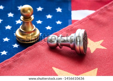 Fighting chess pawn on China and US national flag. Trade war and conflict between countries concept.